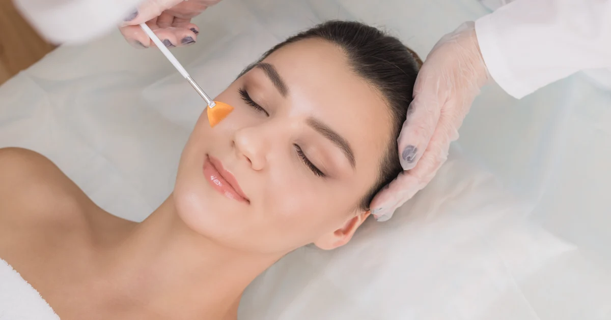 Woman receiving a chemical peel treatment for skin rejuvenation at Skincredible